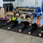 Group of women exercising with pilates ring